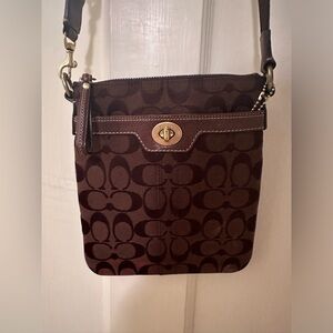 Coach crossbody purse in dark brown with gold detail.
